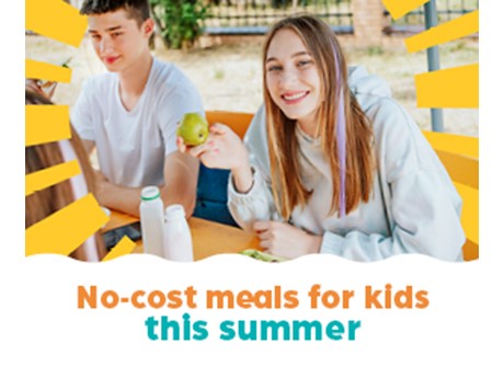 A teen boy and girls smile at the camera. The girl is eating an apple. Text under the image reads: No-cost meals for kids this summer