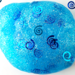 light blue slime ball with spiral confetti in and around it