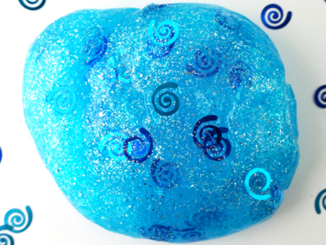 light blue slime ball with spiral confetti in and around it