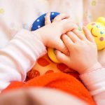 Baby Hands on a Blanket with toys