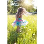 girl twirling in a field of flowers