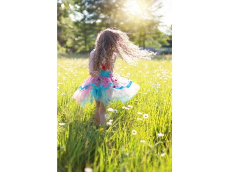 girl twirling in a field of flowers
