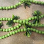 A string of green mokihana berries on a lei