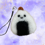 Onigiri key chain charm against a purple background