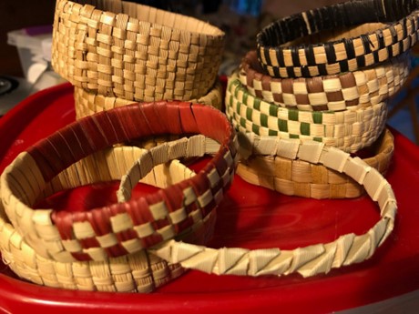 Tan bracelets woven from the lauhala plant.