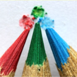 Close-up view of three colored pencils