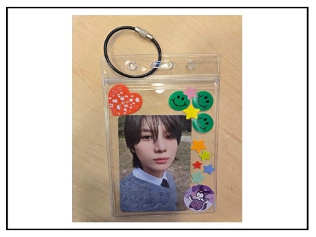 photograph in a zip top holder decorated with stickers with a keyring