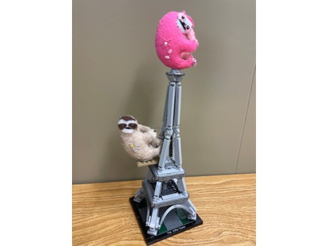 pink and light brown sloths on eiffel tower
