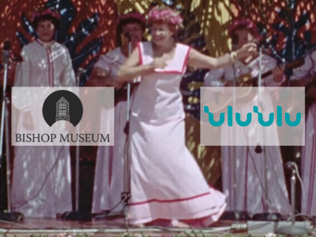Woman dancing hula on stage; Bishop Museum logo and ʻUluʻUlu Moving Image Archive logo on either side of her.