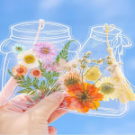 clear bookmarks in the shape of jam jars with dried flowers inside and tassels.