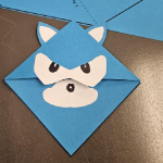 blue book corner with 2 ears, eyes, and a snoot to resemble sonic the hedgehog