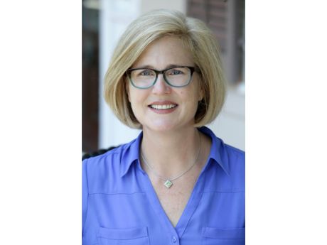 a smiling woman wearing glasses