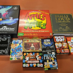 Assorted table top games including Apples to Apples, Fluxx, Sushi Go and more.