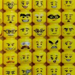 Vertical rows of LEGO minifigure heads with different expressions