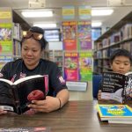 Mother and son reading in the library