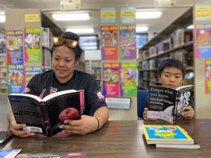 Mother and son reading in the library