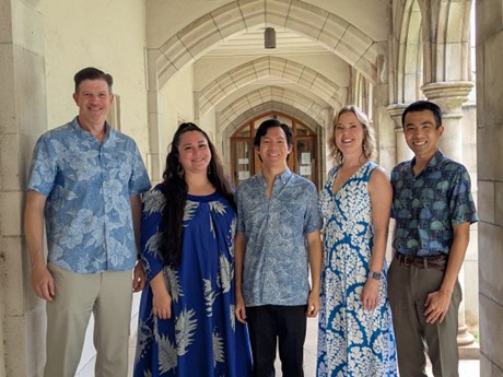 Five singers (3 male, 2 women) standing in corridor