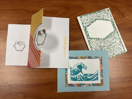 one card with dog embellishment and envelope, one blue card with stamped tidal wave, and one card with green lattice design