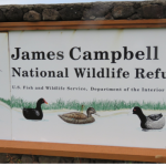Sign reads James Campbell National Wildlife Refuge and features illustrations of four native birds.