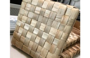 A tan hot pad woven from the lauhala plant.