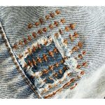 Color photo image of a mending patch on denim.