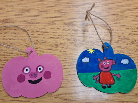 2 wooden pumpkins painted.
