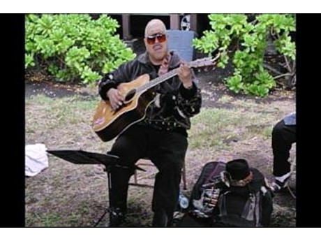 Ledward Kaapana playing guitar