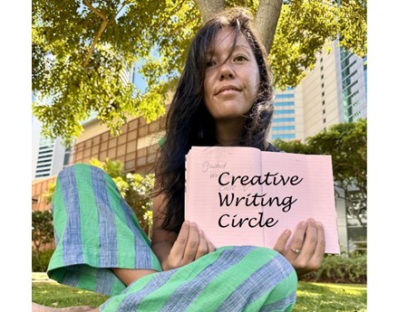 photo of woman sitting on grass