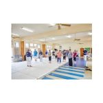 class of people standing on mats