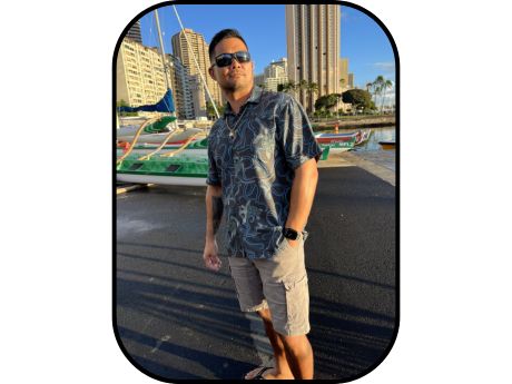 man standing on pier, shirt, shorts, and sunglasses