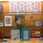 display of kokeshi doll, artworks and books on the dolls