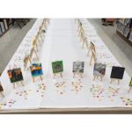 tiny paintings set up on tiny easels