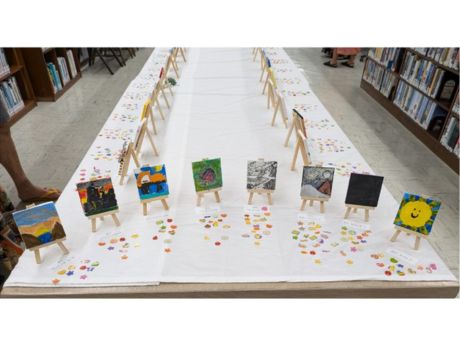 tiny paintings set up on tiny easels