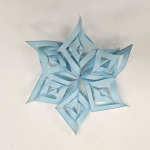 light blue paper snowflake on white background