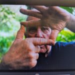 Man framing his face with his hands with a screen overlay