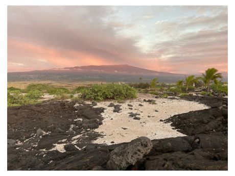Hualalai volcano behind beach in Kailua-Kona Hawaii