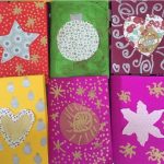 six brightly colored handmade cards lined up in two rows