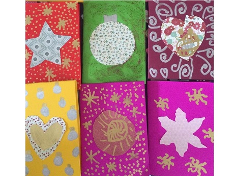 six brightly colored handmade cards lined up in two rows