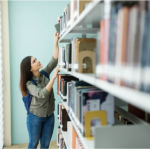 teen looking for a book on the top shelf