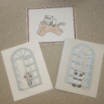 Three handmade cards, one with stamped panda on horse, and the other two with glued paper window and stamped flower and panda