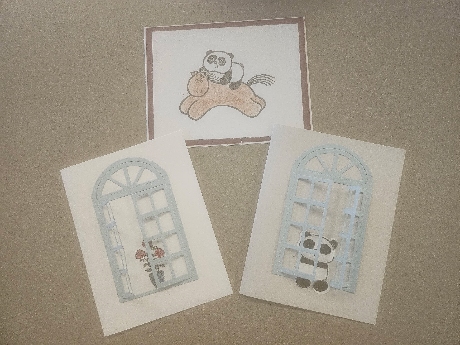 Three handmade cards, one with stamped panda on horse, and the other two with glued paper window and stamped flower and panda