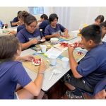 Group of students preparing strawberry whipped cream tea sandwiches