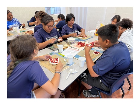 Group of students preparing strawberry whipped cream tea sandwiches