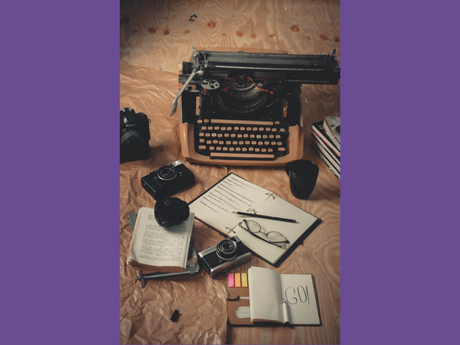 typewriter, writing implements, cameras on desk