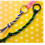 two Japanese braided cords against a yellow backdrop