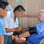 A healthcare professional checks the blood pressure of a patient