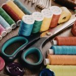 scissors with yarn needles and buttons of various colors