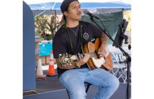 seated man playing guitar