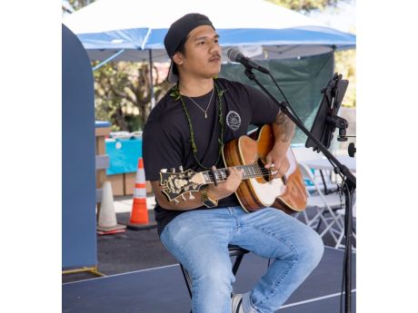 seated man playing guitar
