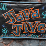 Black sign with the words Java Jive in blue and orange against a rock wall. The numbers 30s 40s and 50s are also on the sign.